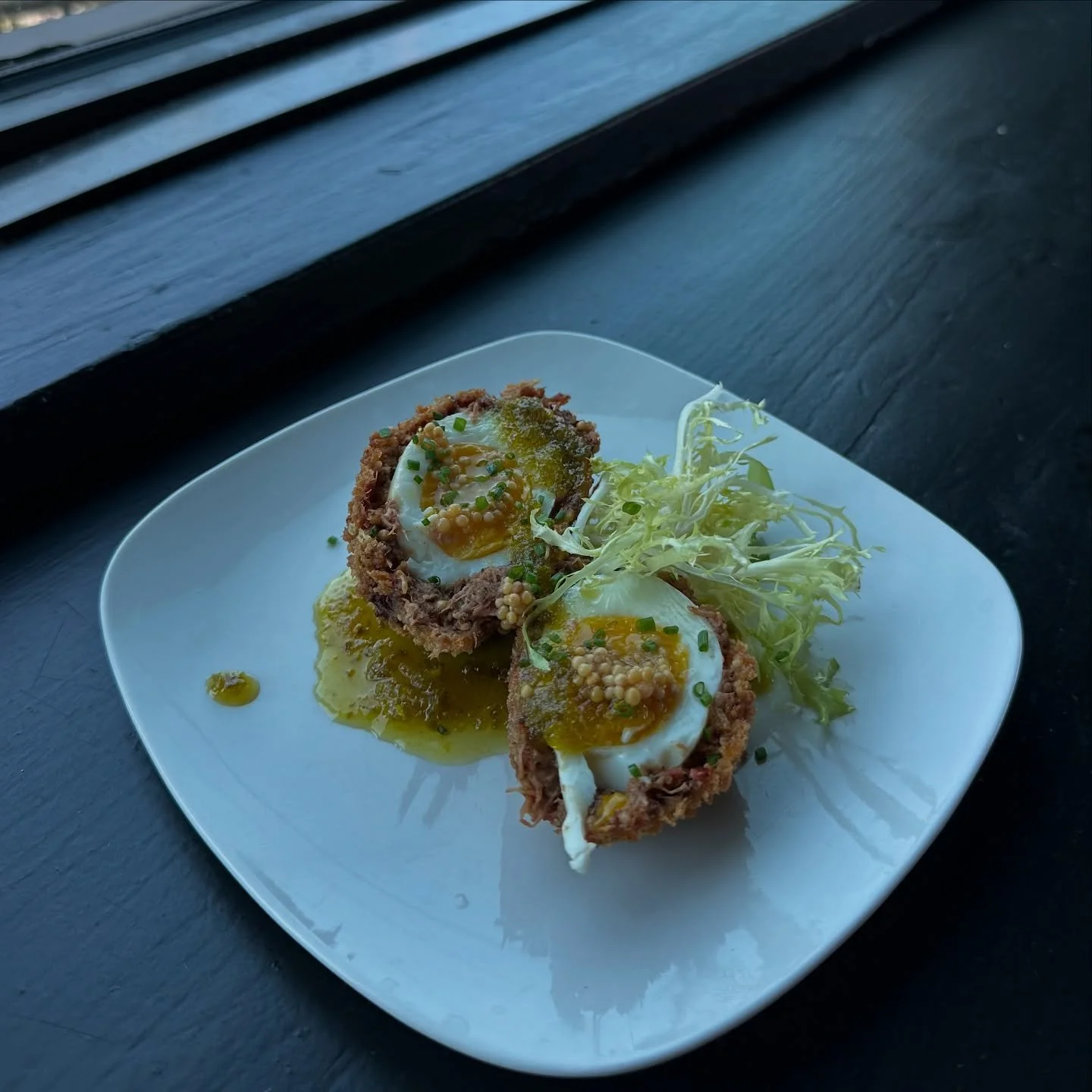 Good mornings start with eggs &amp; meat like this scotch egg with pulled pork, jalape&ntilde;o jam, and pickled mustard seed. Happy Sunday y'all!