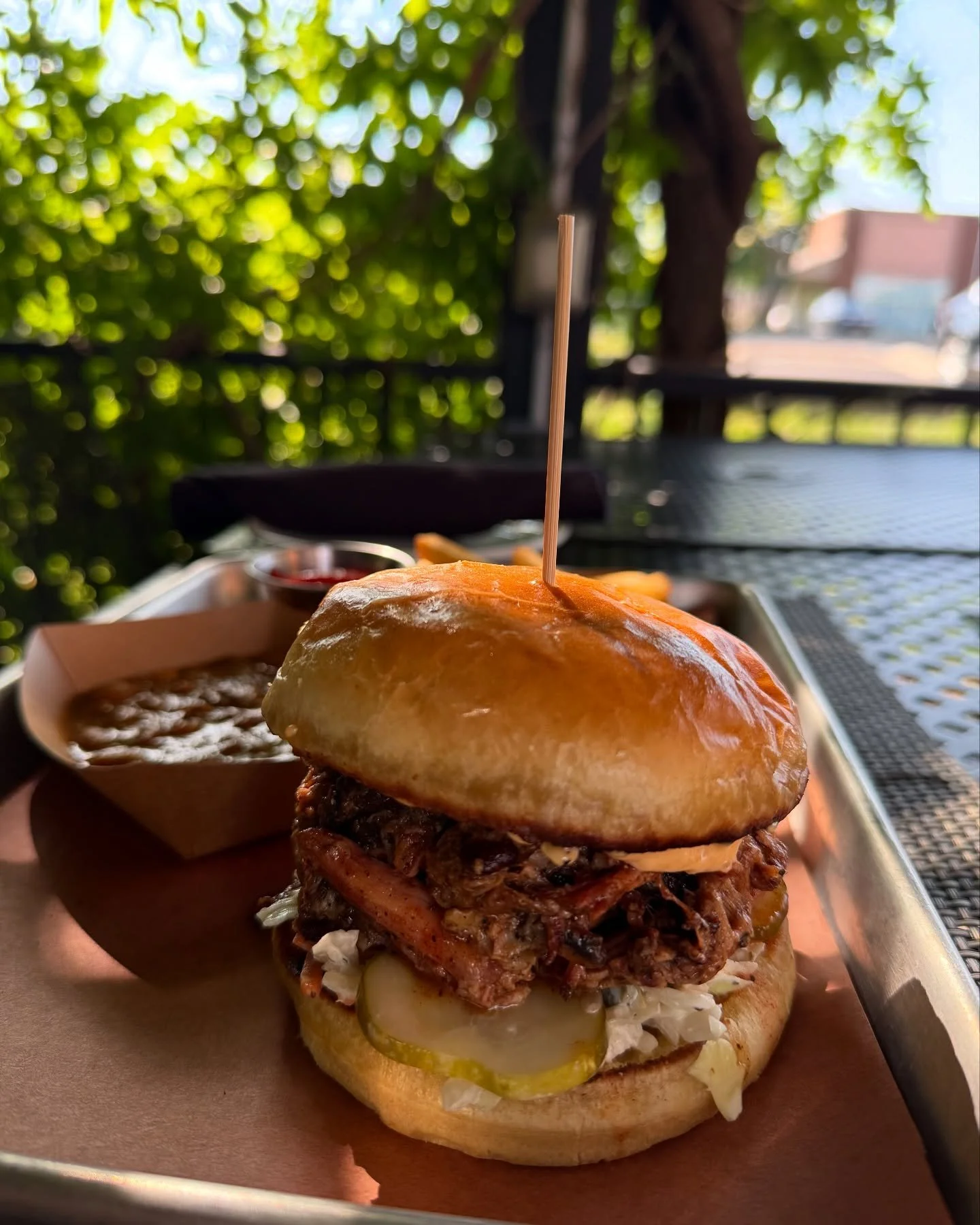 Keepin' it goin 😎 🇺🇸 with this &mdash;Carolina pulled pork, pimento cheese &amp; pickle slaw on a brioche bun with pit beans &amp; fries while keepin it cool w a Strawberry Lemon Drop Spritz 🍓🍋💦