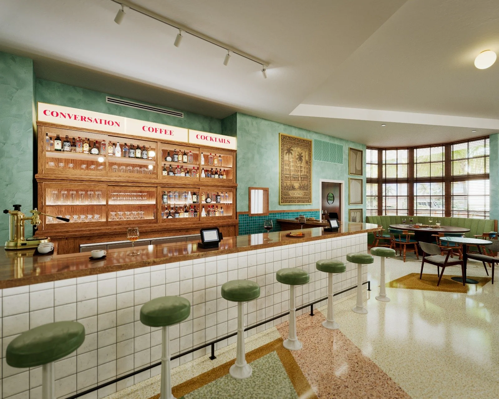 Interior of a retro-style café with a wooden bar counter, green bar stools, a display of liquor bottles, and a seating area with a curved window and green upholstery.