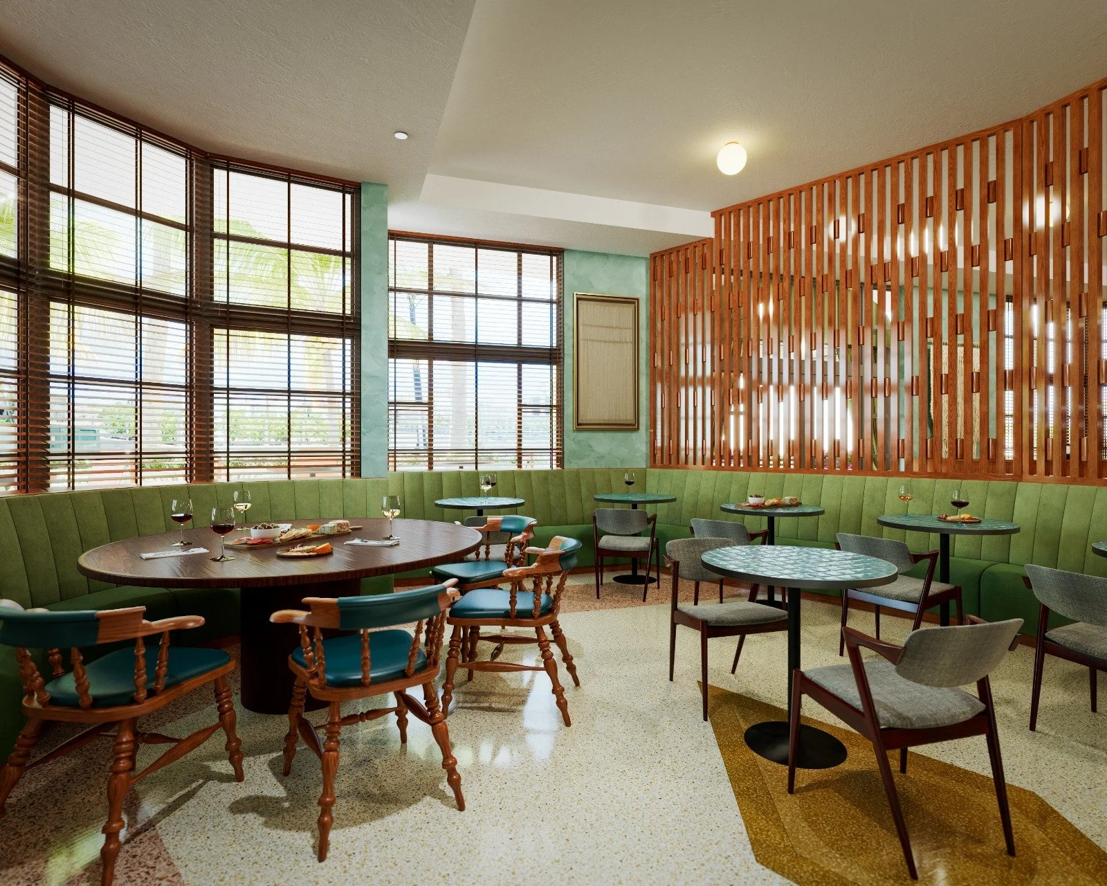 Interior view of a restaurant with green seating, wooden tables, and a large window with blinds. There are some glasses of wine and plates of food on the tables, and a decorative wooden partition divides the space.