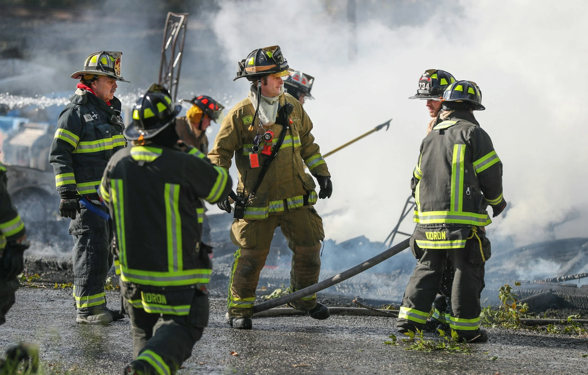Firefighters in protective gear working together in heavy smoke, representing first responder trauma therapy in Evergreen, CO