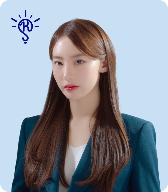 A young woman with long brown hair wearing a dark blazer and a white top, against a light blue background with a blue lightbulb icon containing a dollar sign near her head.