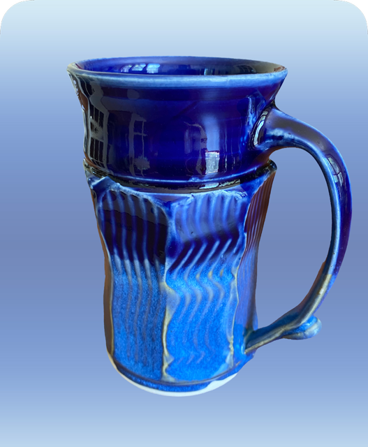 A blue ceramic mug with a handle, featuring textured vertical stripes and a glossy finish.
