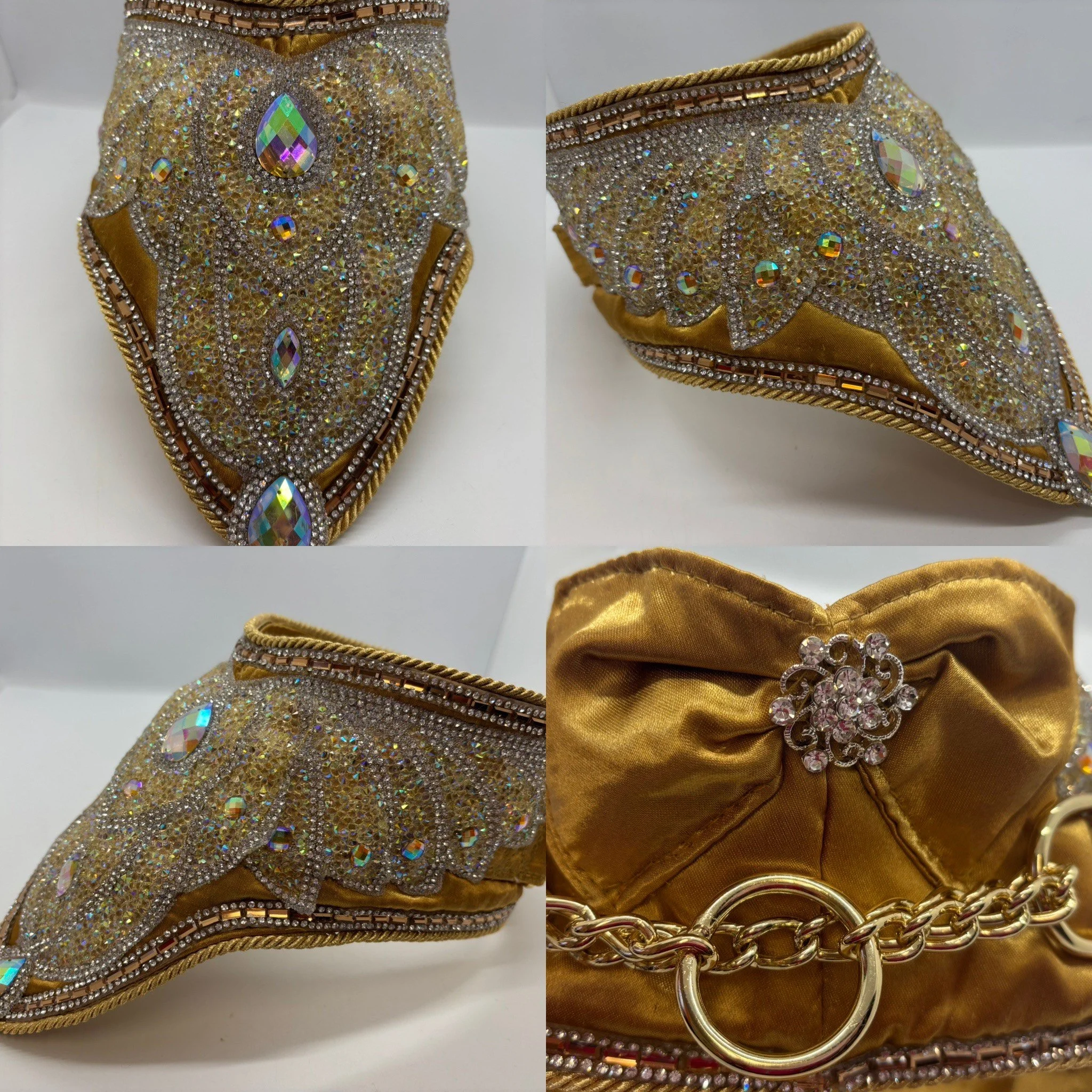 A gold-colored clutch purse decorated with rhinestones and crystals, featuring diamond-shaped and oval embellishments, and a chain strap with a toggle clasp.