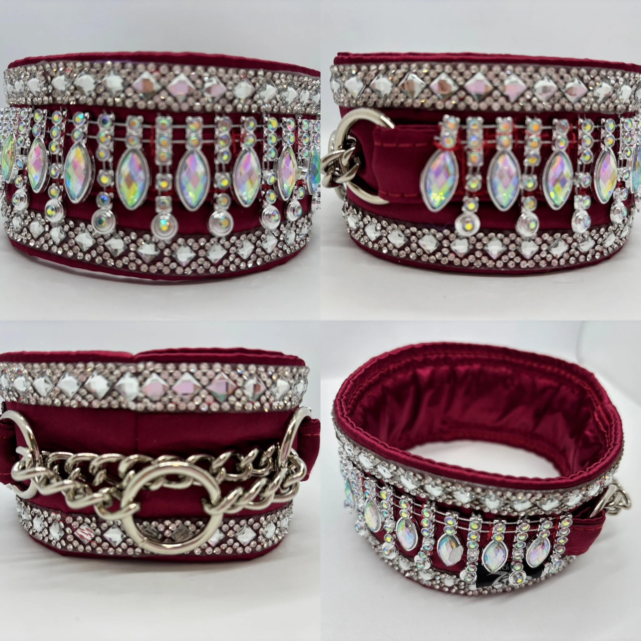 A red fabric dog collar decorated with rhinestones and hanging iridescent teardrop-shaped pendants, with a silver chain and ring at the back for leash attachment.