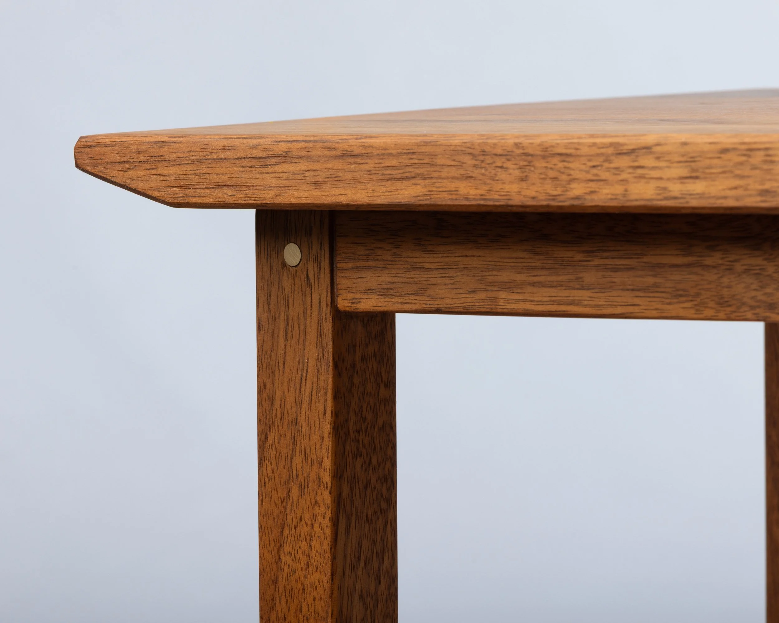 Close-up of a wooden table corner.