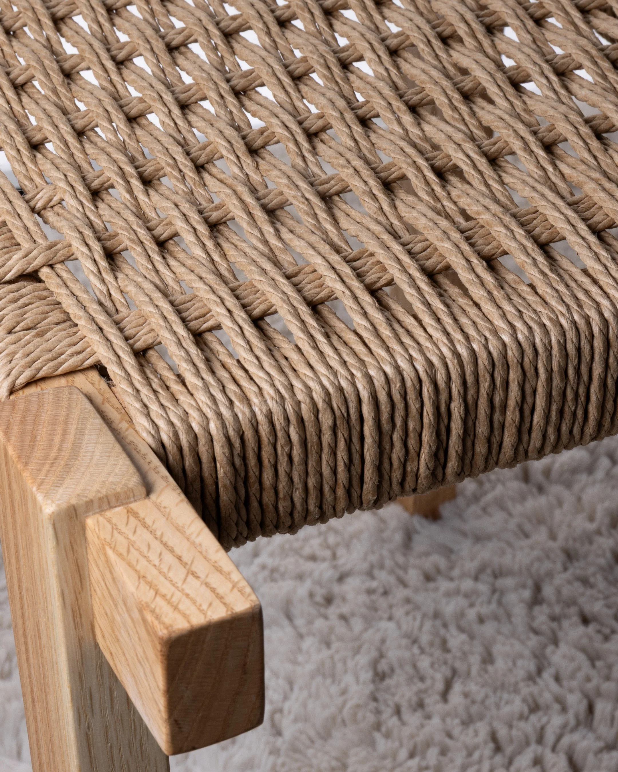 Close-up of a stool with a Danish woven seat.