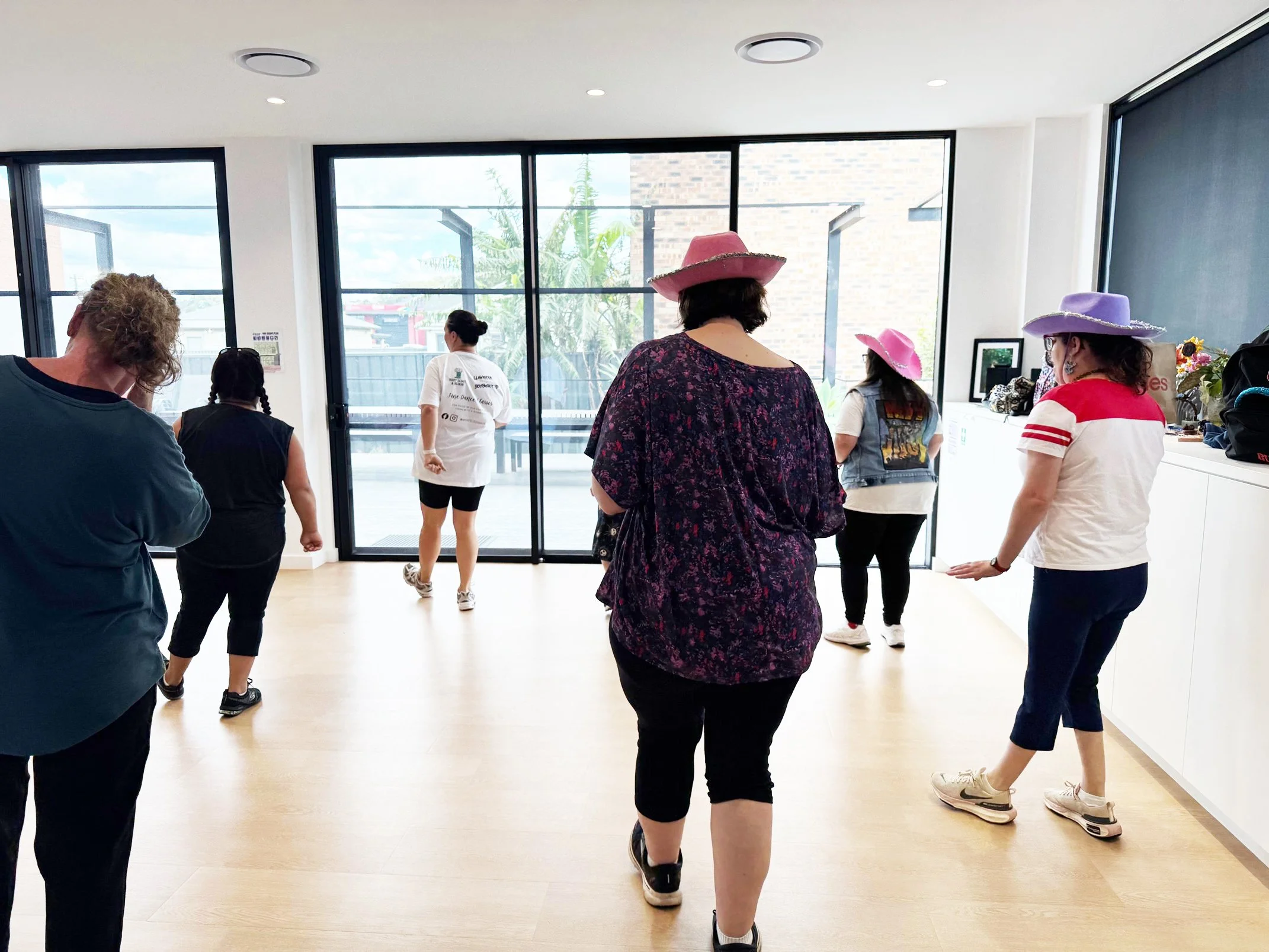 Group of women doing line dancing following a teacher in front