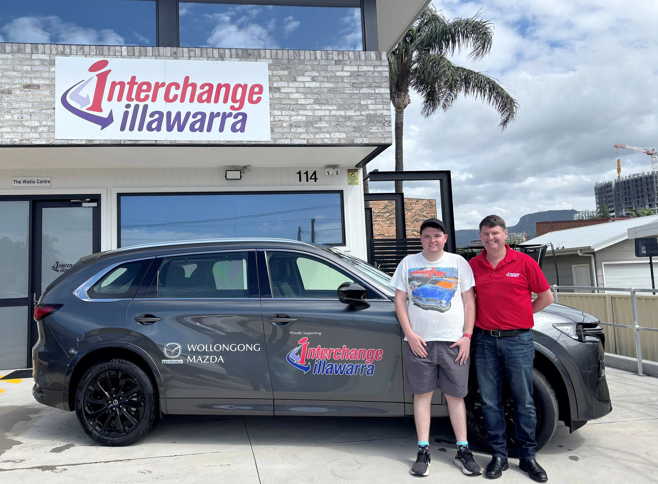 Braydon from Squeaky Clean Cars with our CEO in front of Interchange building