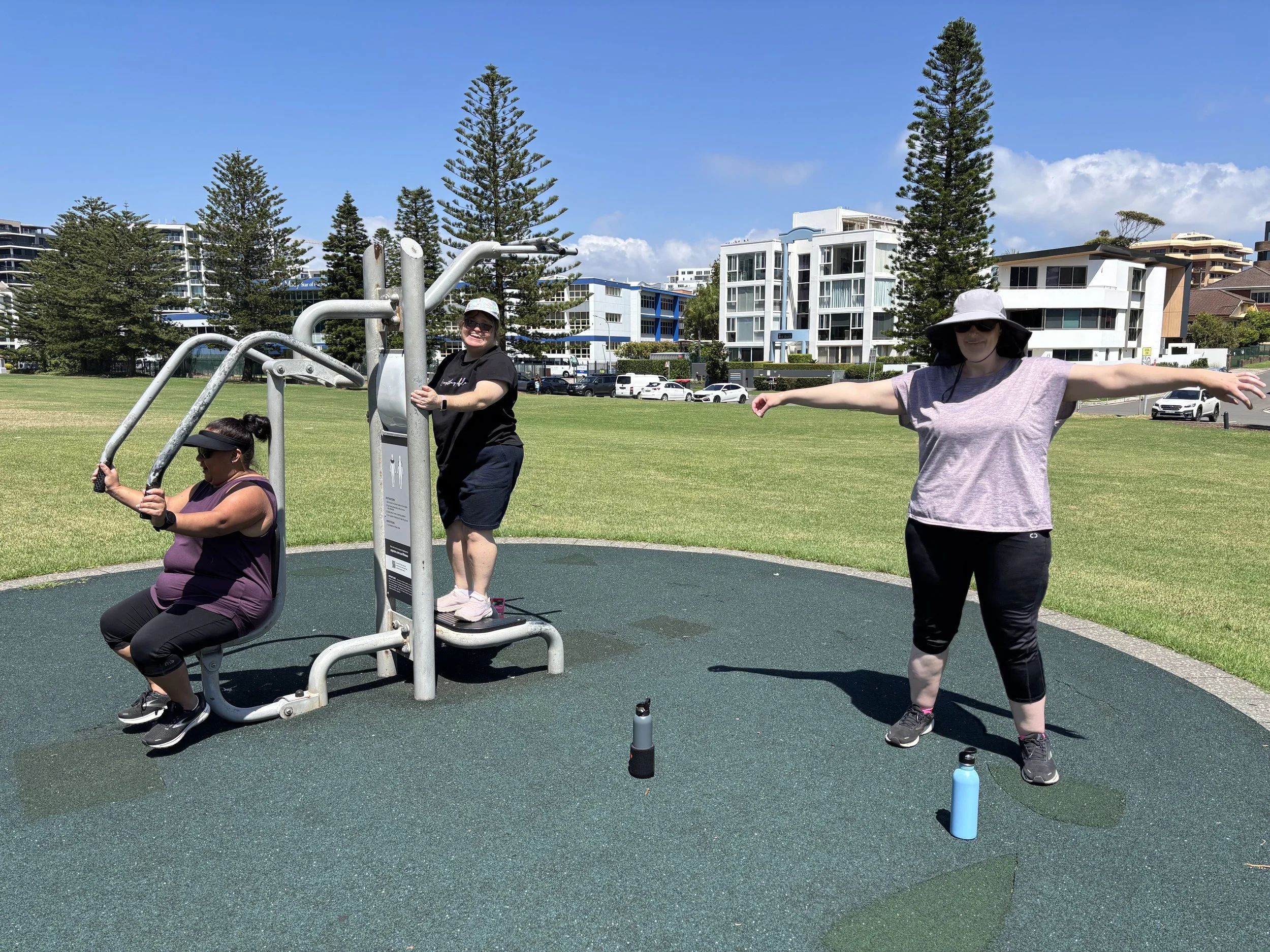 A group of participants undertaking exercise on outdoor equipment