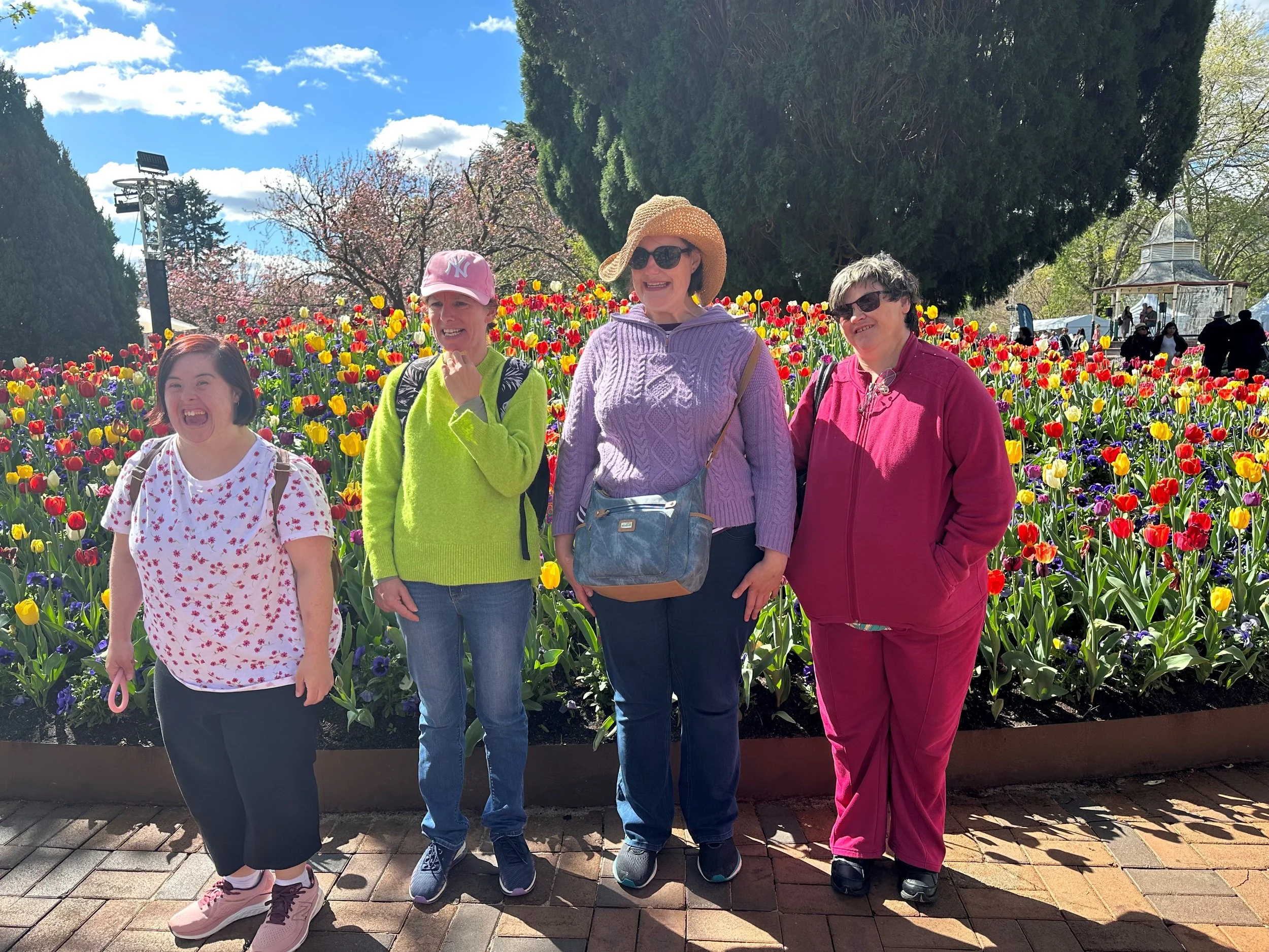 Female participants in front of a tulip garden