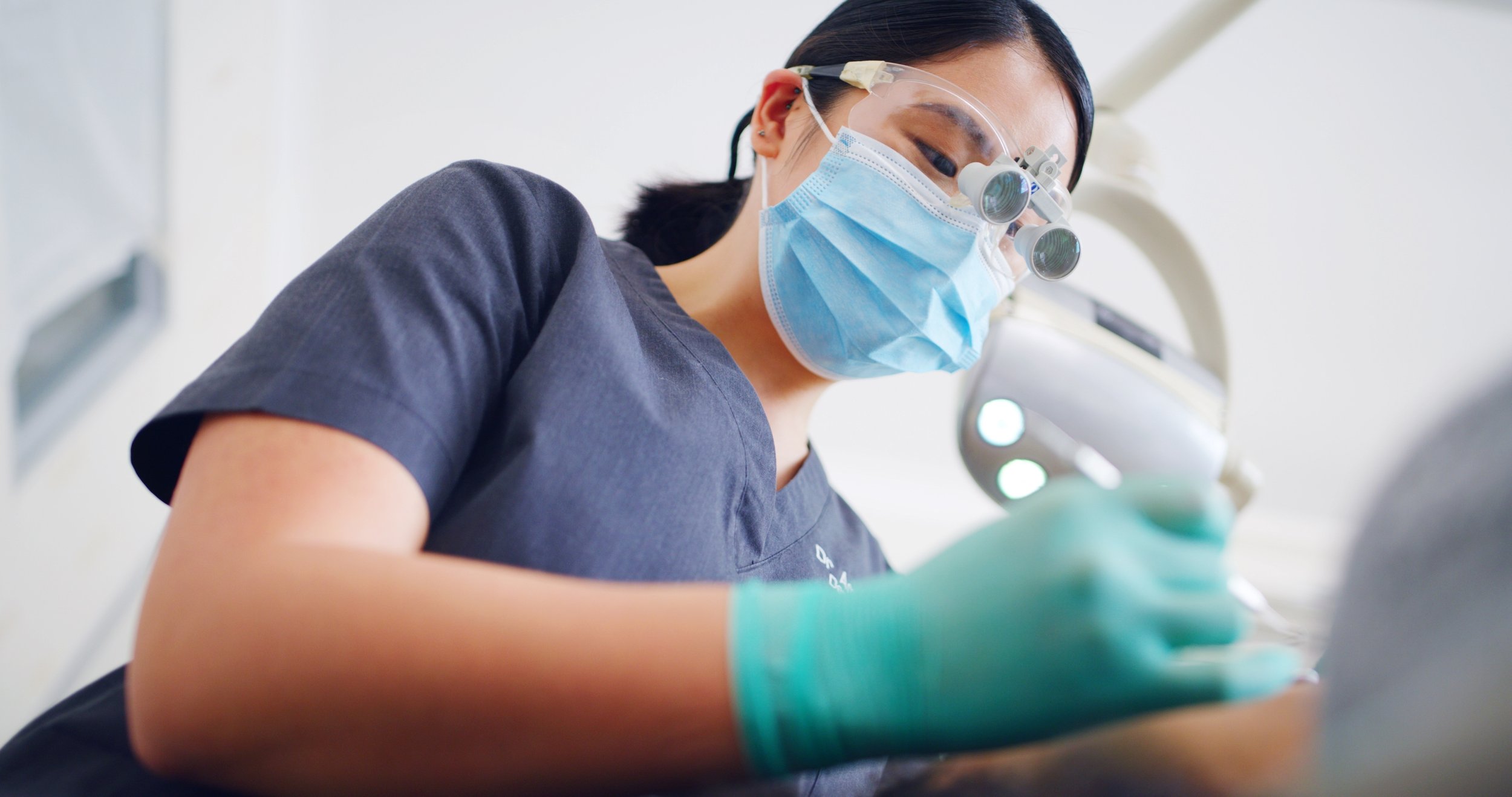 Female dentist with a mask and gloves on