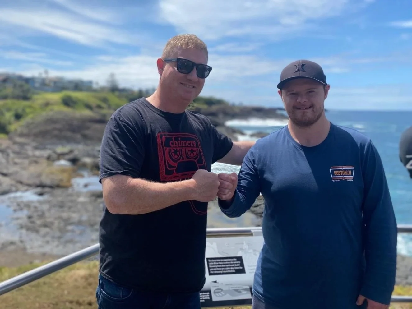 Participant and Social Support Manager bumping fists at a lookout