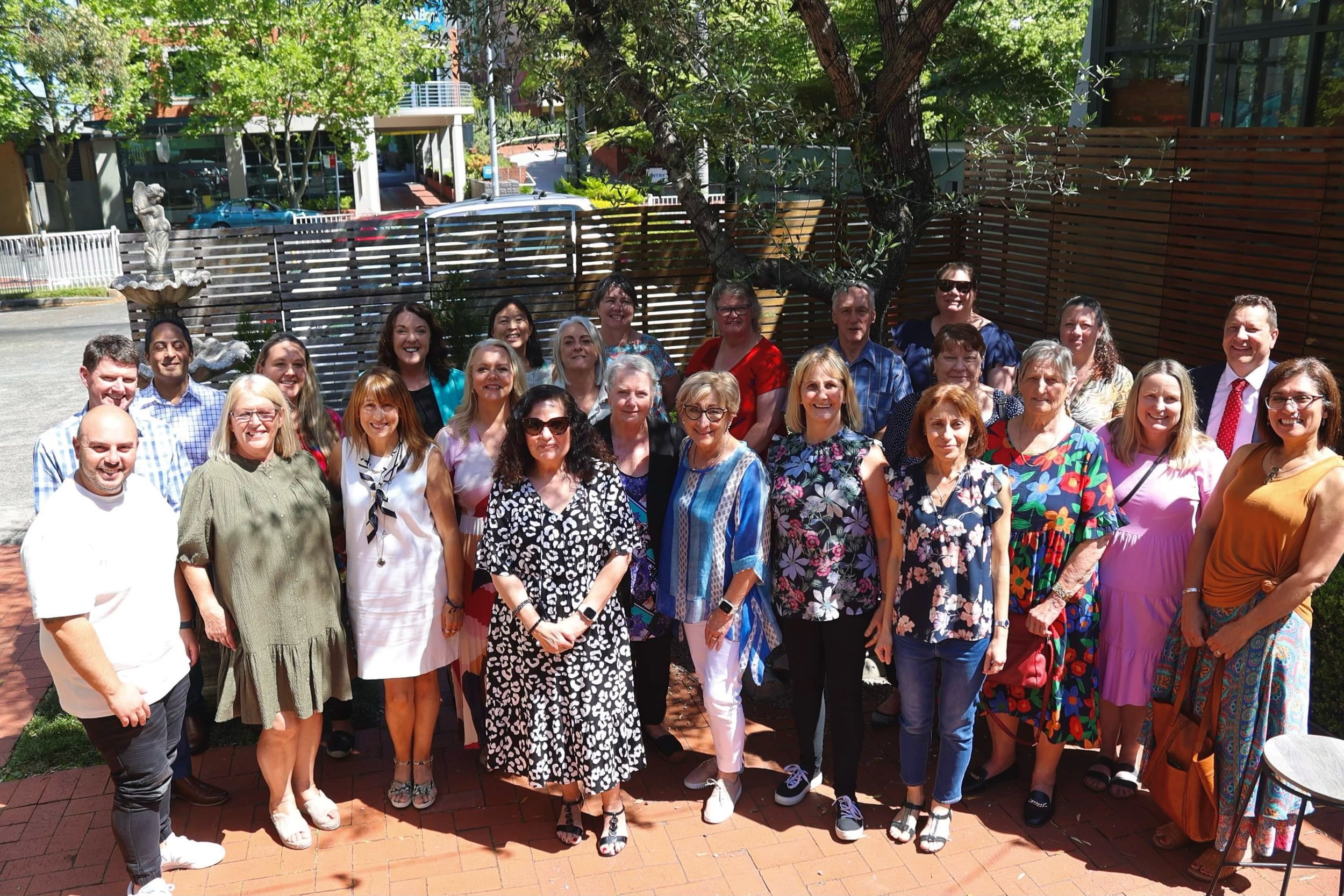 Group of parents and carers standing outside after attending a Carers Week lunch 