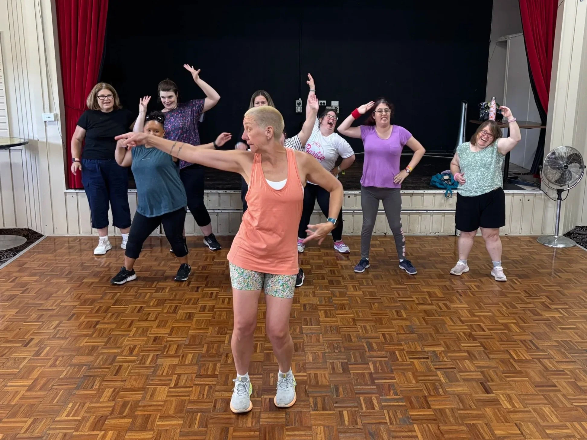 A photo of a woman leading a Zumba class