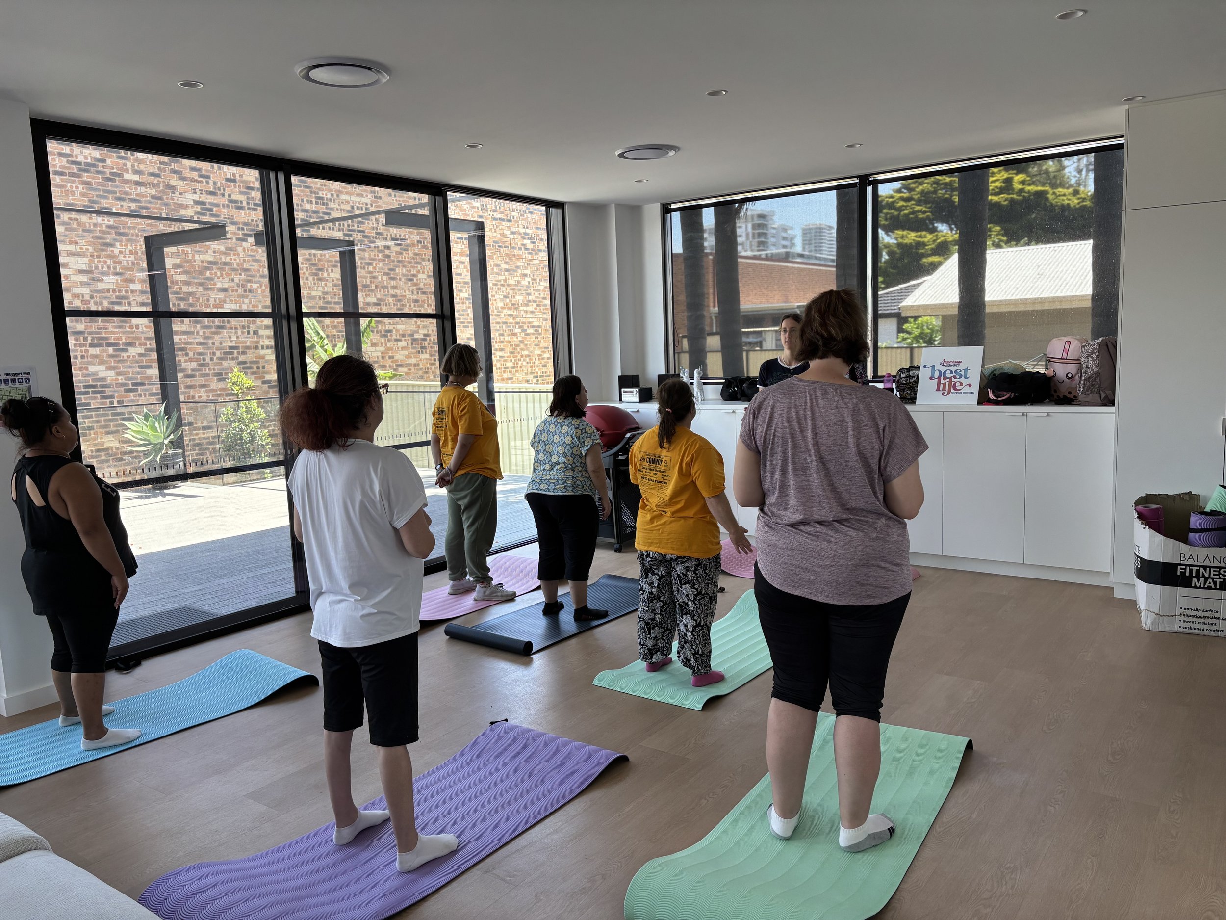 A group of people doing indoor yoga