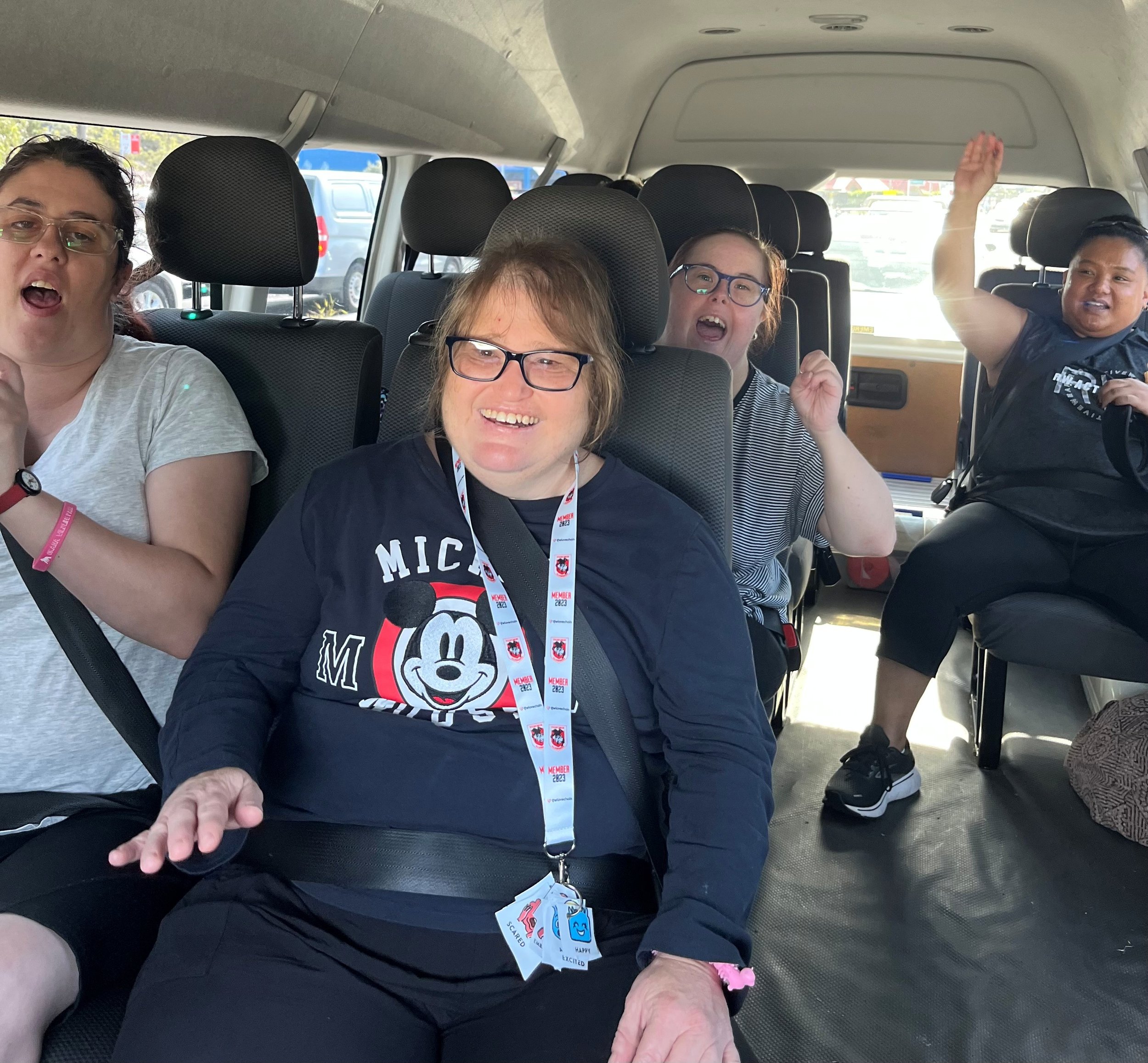 A group of happy participants inside a mini bus
