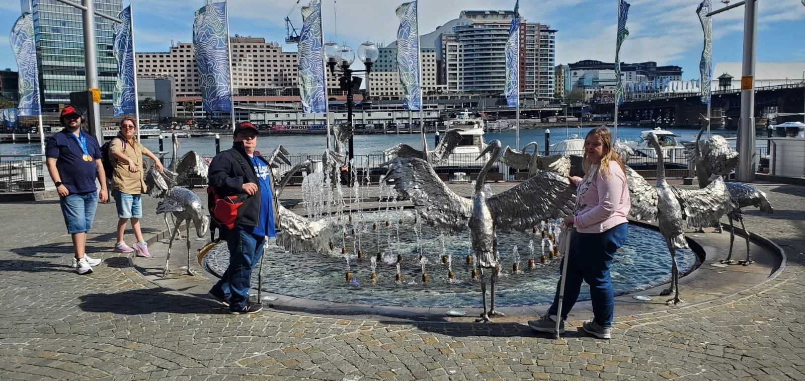 Participants posing in front of a sculpture in Sydney