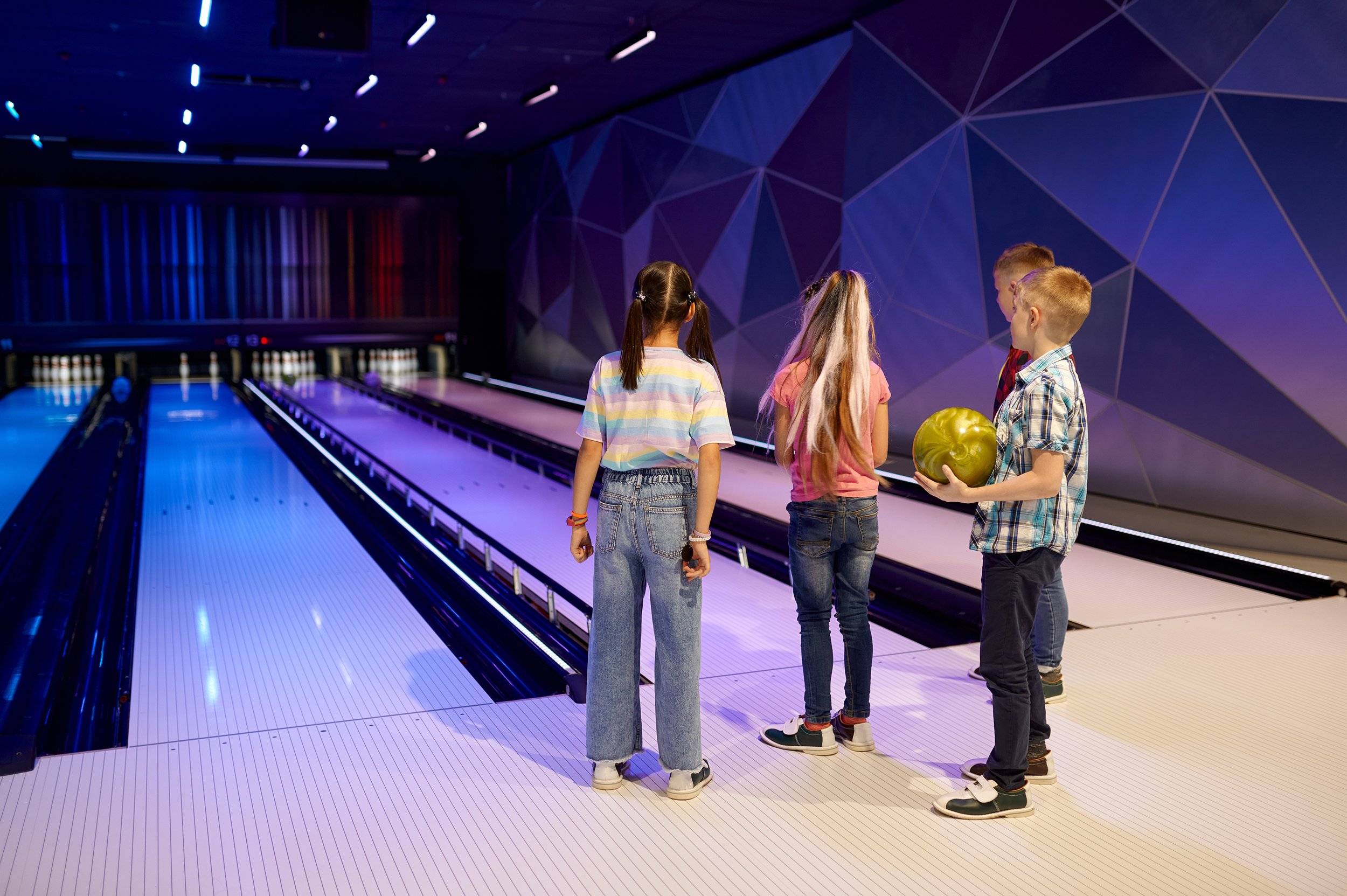 Four children at a ten pin bowling alley