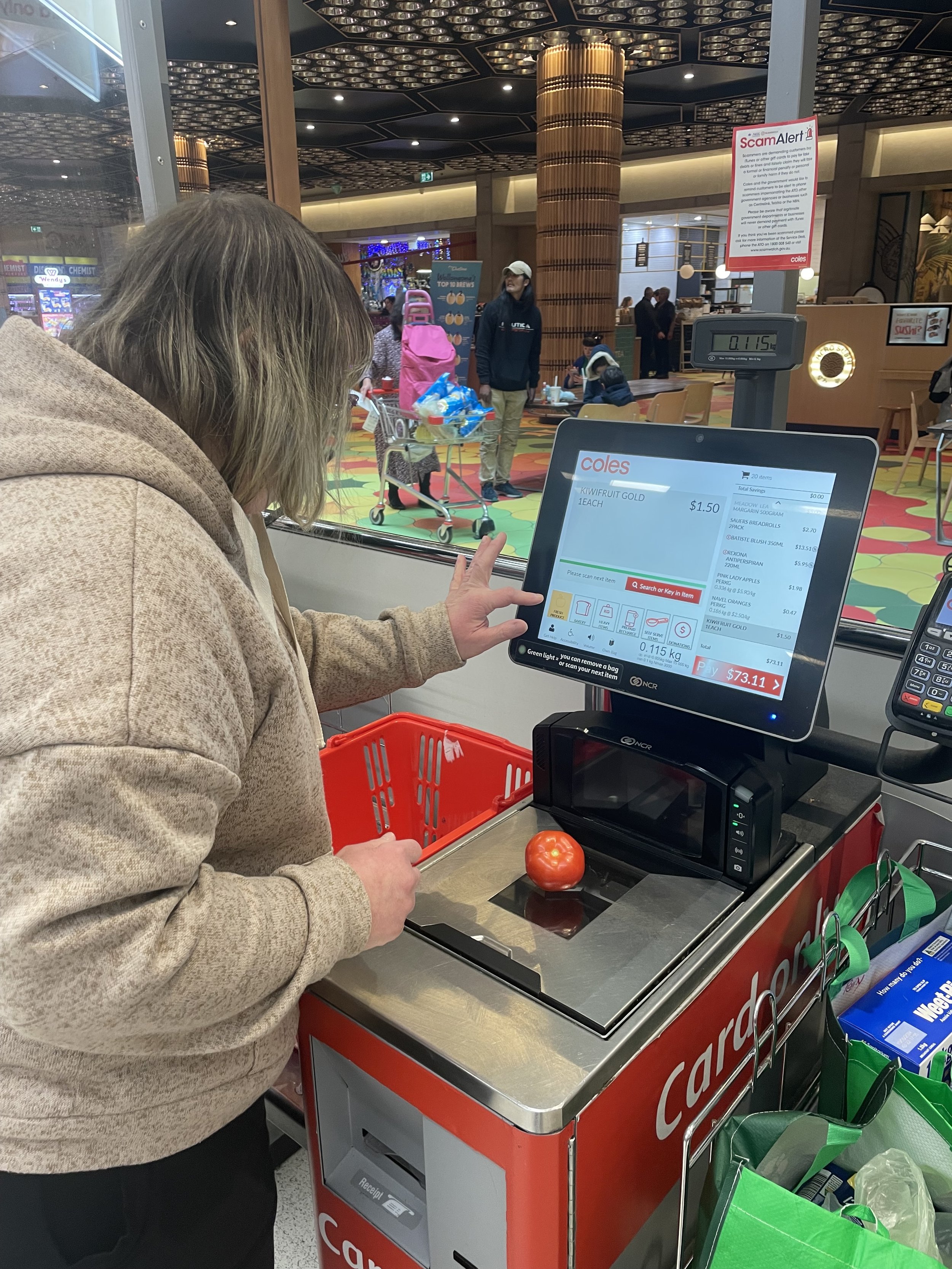 A participant at a Woolies check out