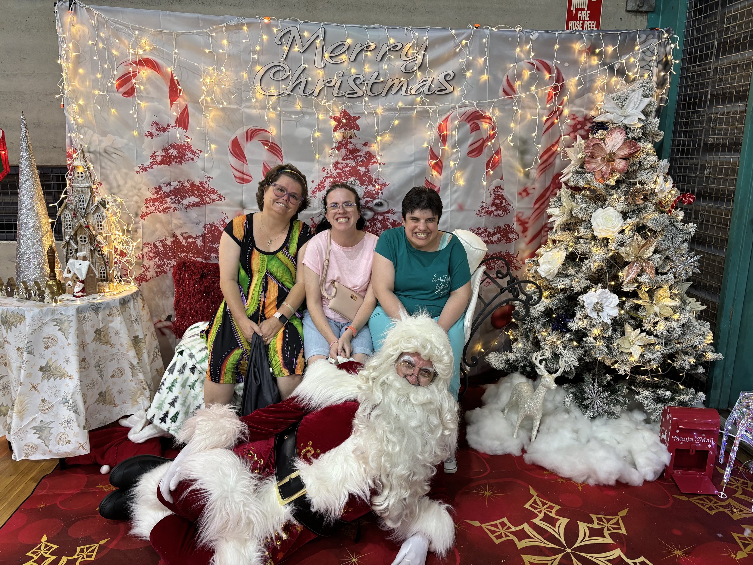 Participants on a bench with santa lying on the floor in front of them