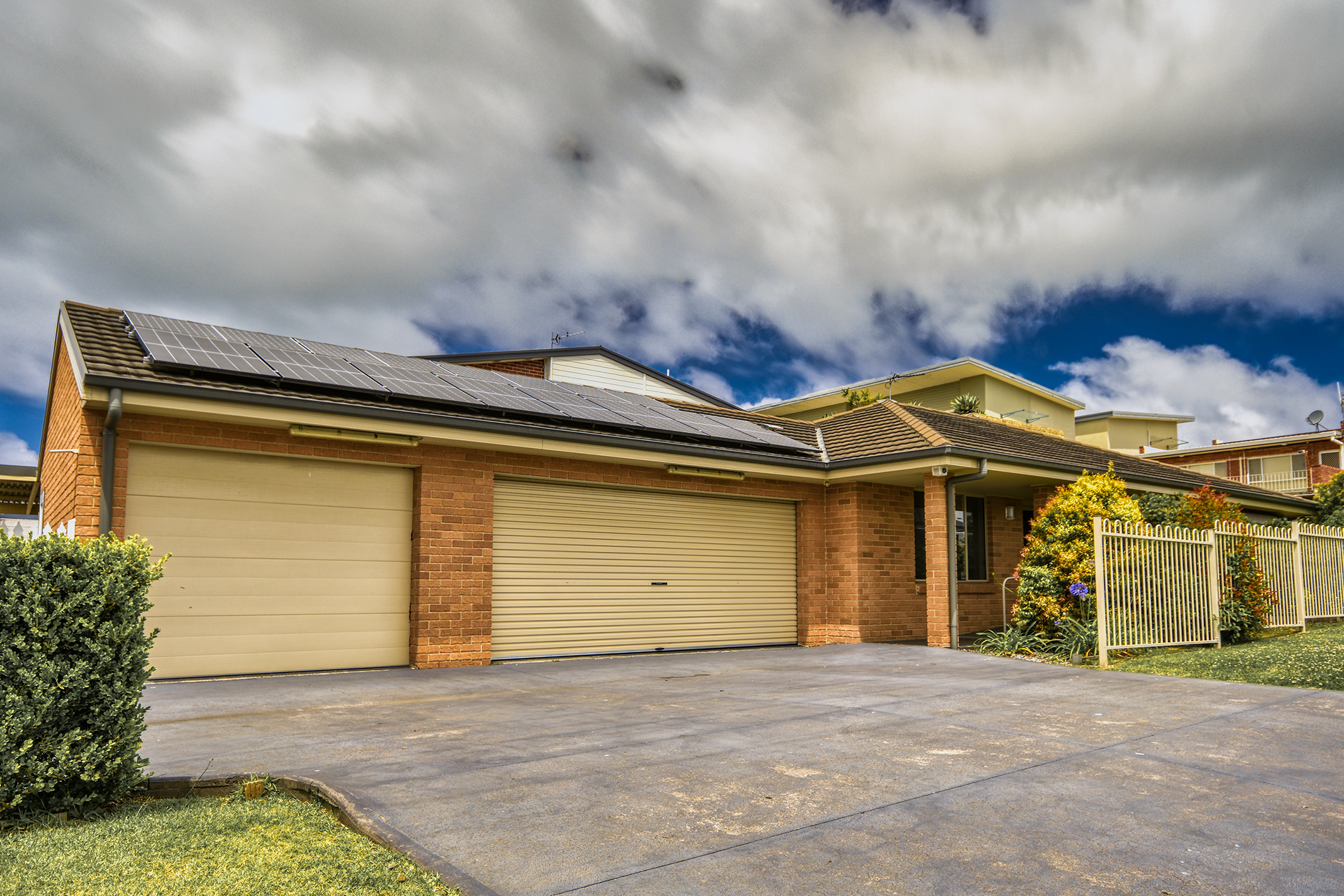 Photo of a villa in Lake Illawarra with gardens and garages
