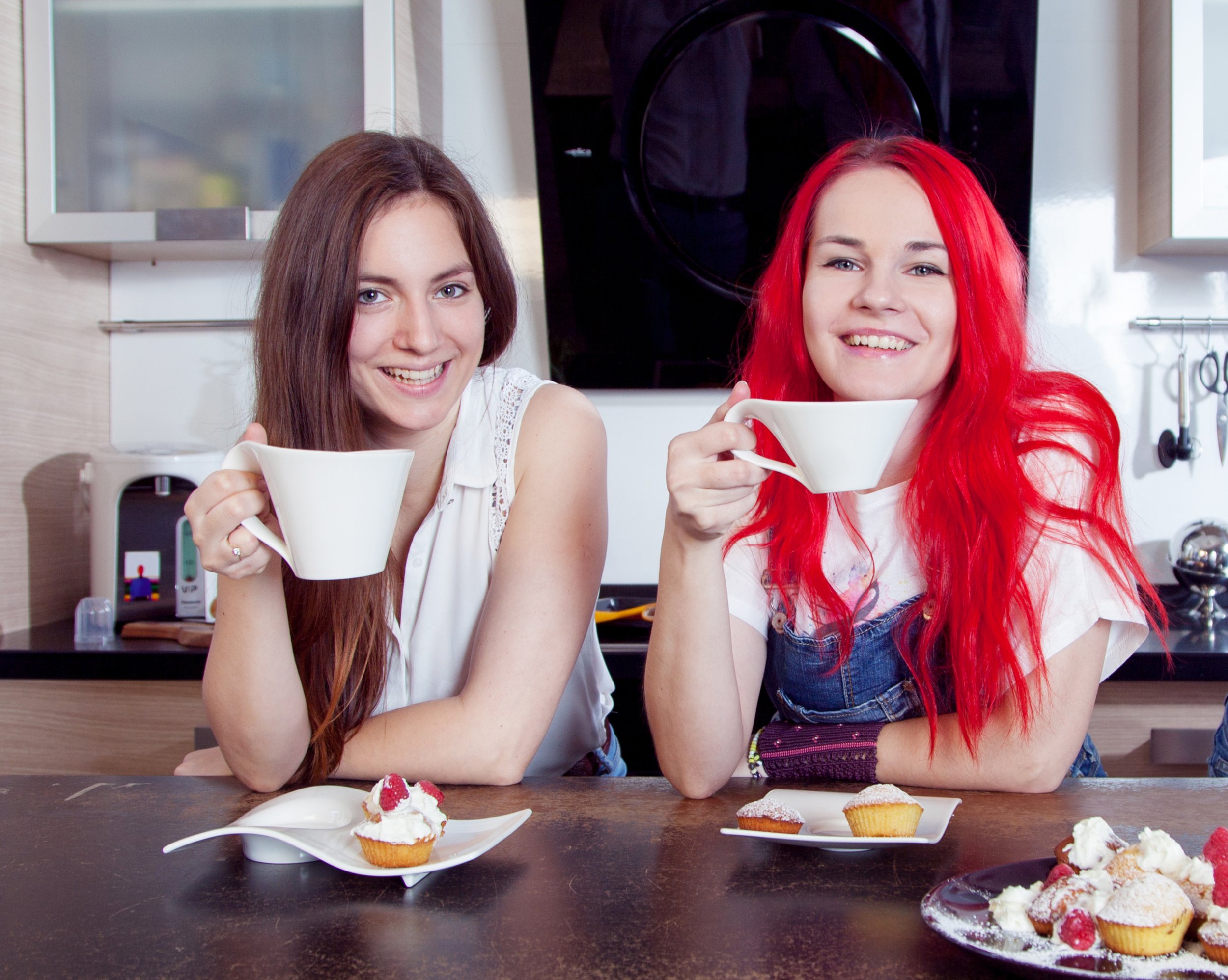 Two young mums enjoying cups of coffee