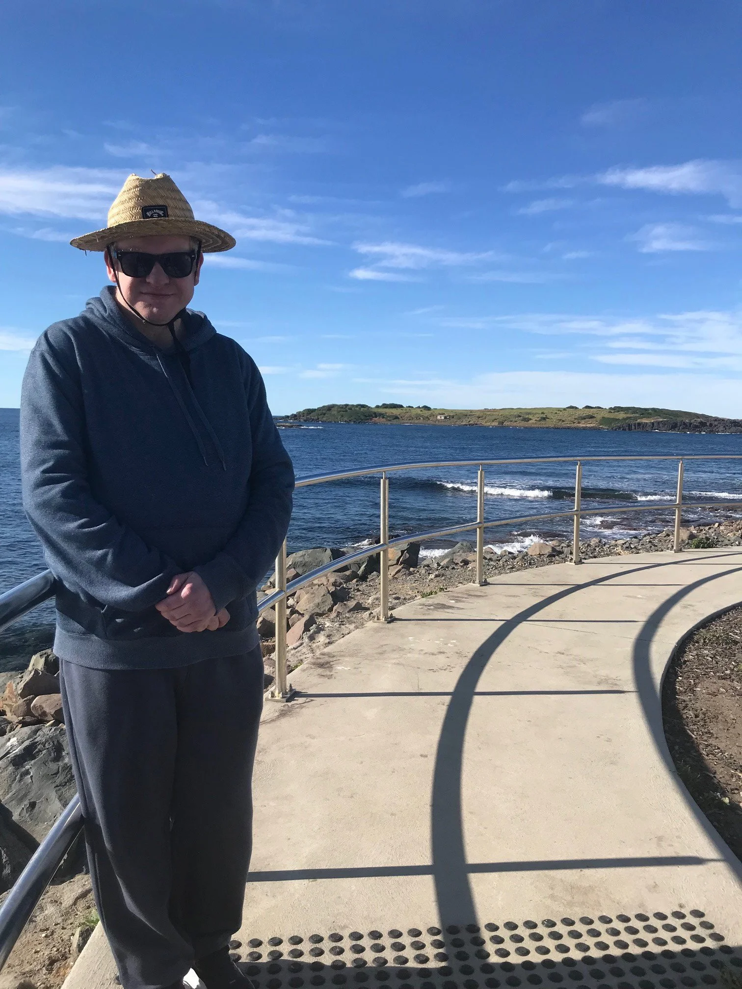 Participant walking on a path by the water at Port Kembla