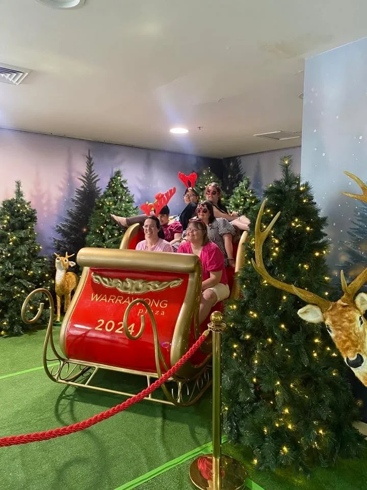 Group of female participants in a santa sled at Warrawong Plaza