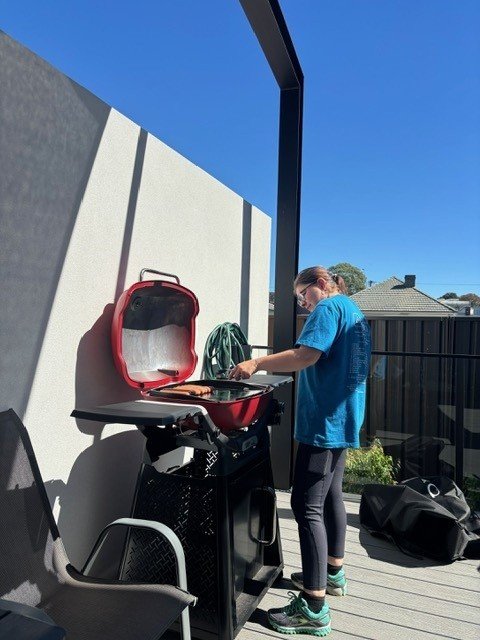 A young woman cooking a barbeque