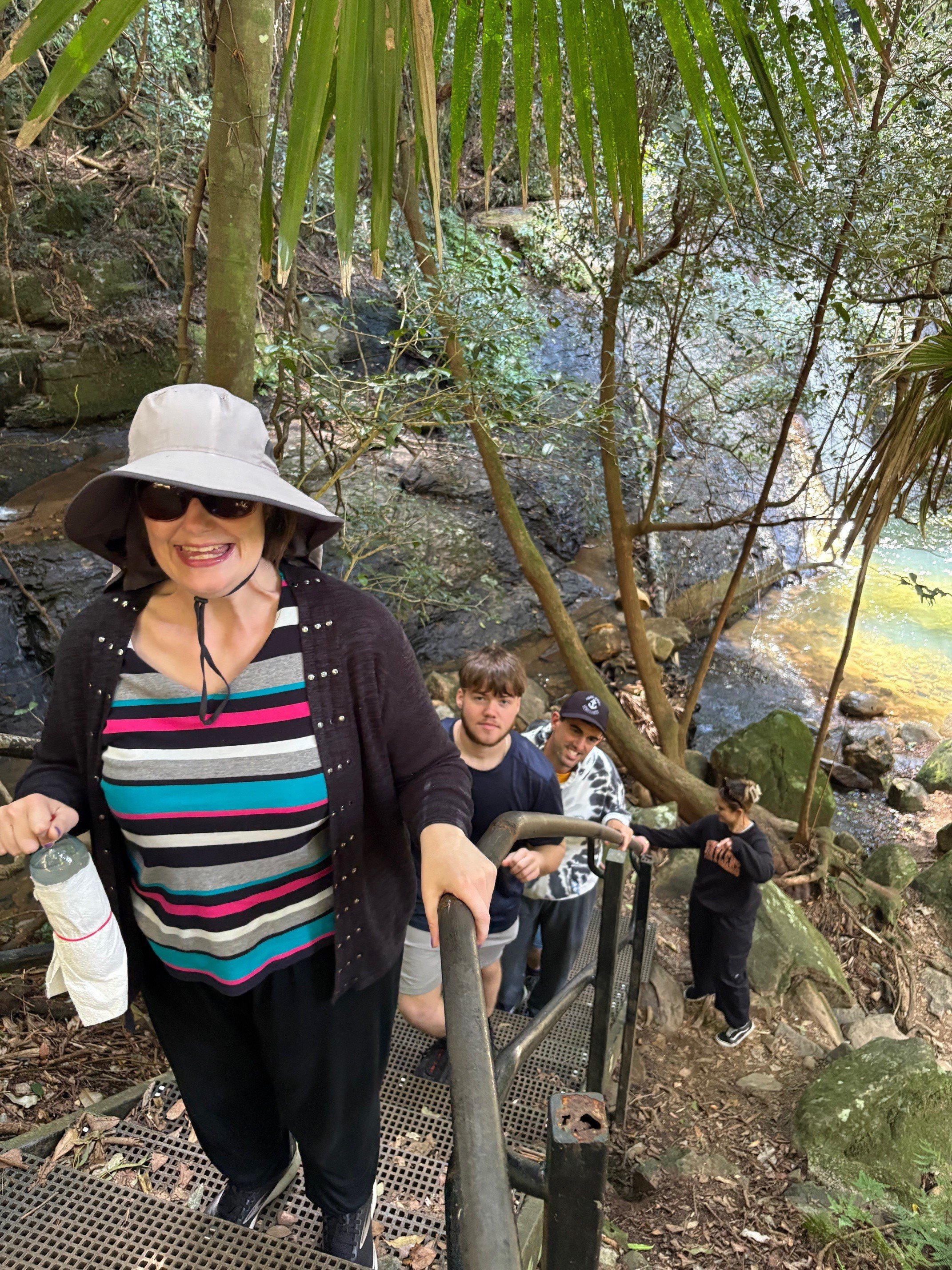 Group of participants coming up a wooden stair case at Minnamurra Falls
