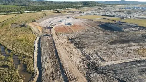 Drone view of road infrastructure and earthworks progressing through a large greenfield civil construction project.