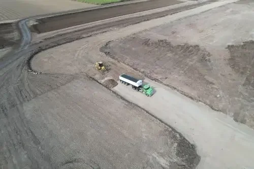 Aerial image of a construction site with a truck and machinery.