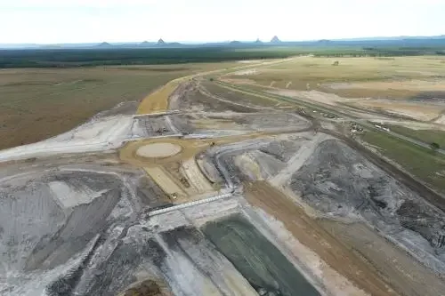 Aerial view of an active construction site with roads and infrastructure in progress in a rural area.