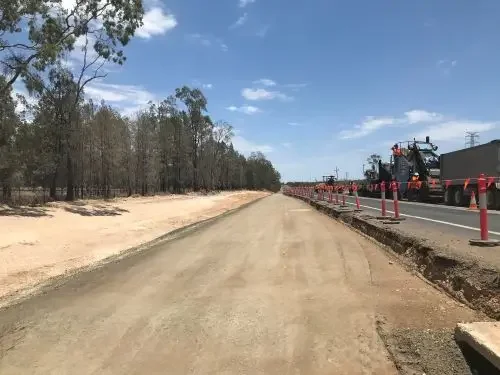 Road construction works with machinery and traffic management during civil infrastructure upgrades.