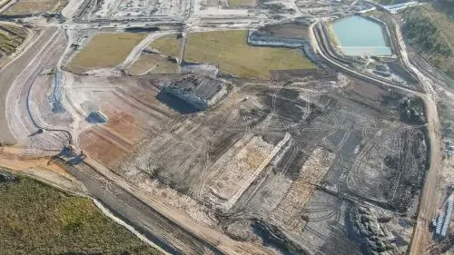 Aerial view of a large civil construction site with earthworks, sediment basins and prepared development lots.