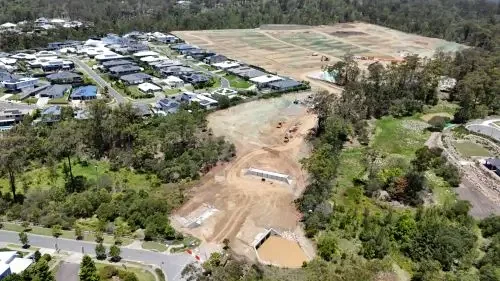 Aerial view of Ellendale residential community. Trees and houses in the background.