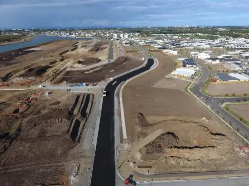 Construction site with ongoing road development at Newport. Water in the background.