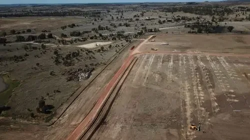 Drone view of bulk earthworks and site preparation for a large industrial or renewable energy infrastructure project.
