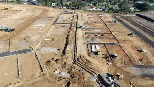 Construction progress at the Botanica masterplanned community, showing earthworks, trenching and underground utility installation.