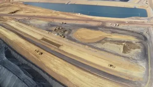 Aerial view of large-scale bulk earthworks and haul roads on a major mining infrastructure construction site.
