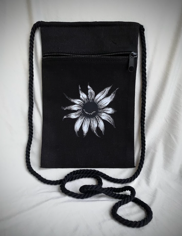Canvas crossbody pouches featuring a smiling sunflower graphic in black and natural colors.