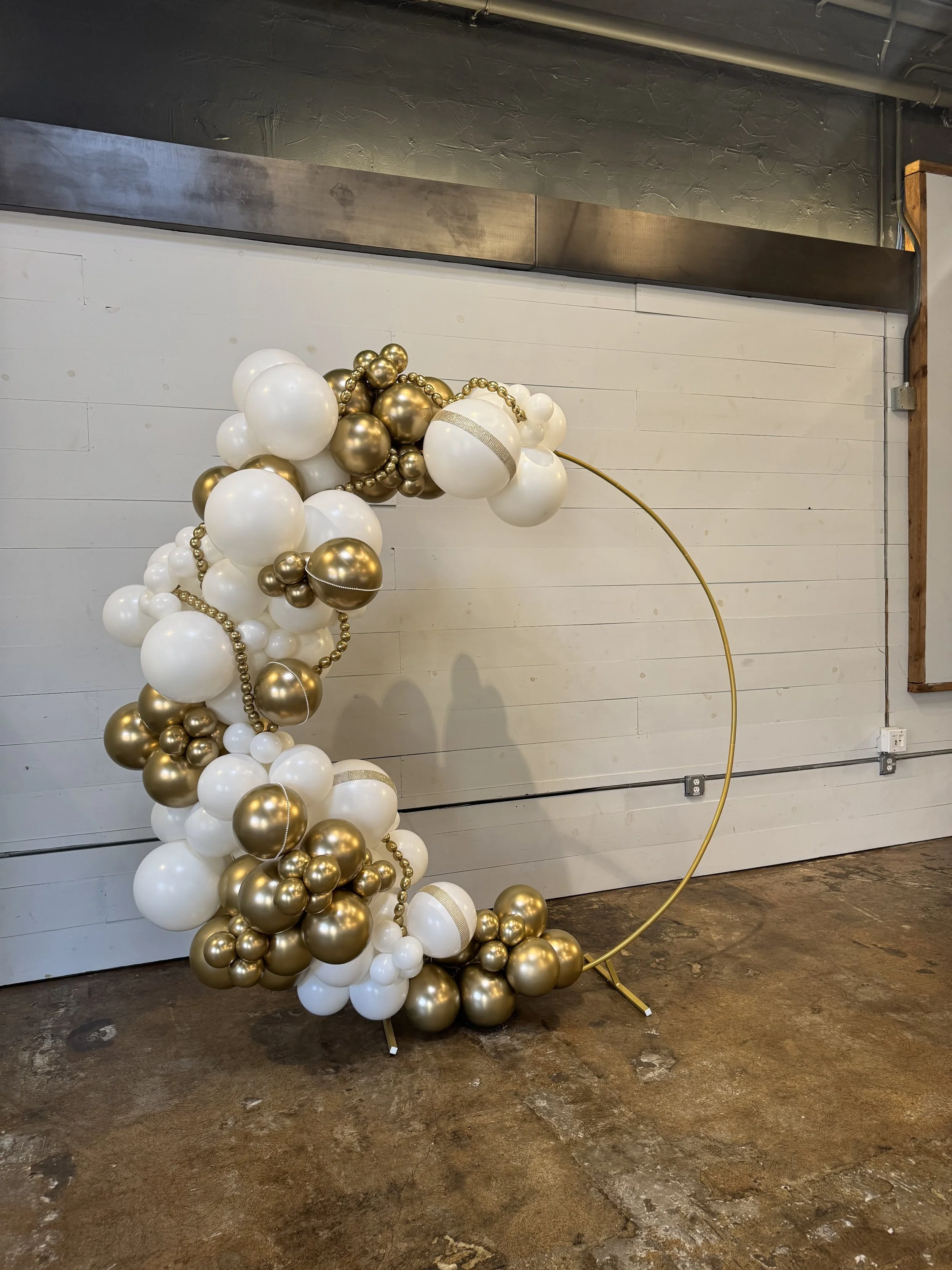 BALLOON HOOP
Starting at $375
A modern circular backdrop styled with organic balloon accents—perfect for photos, entrances, or a statement focal point. Includes the ring stand, balloon styling, delivery, setup, and teardown. Images may show optional 