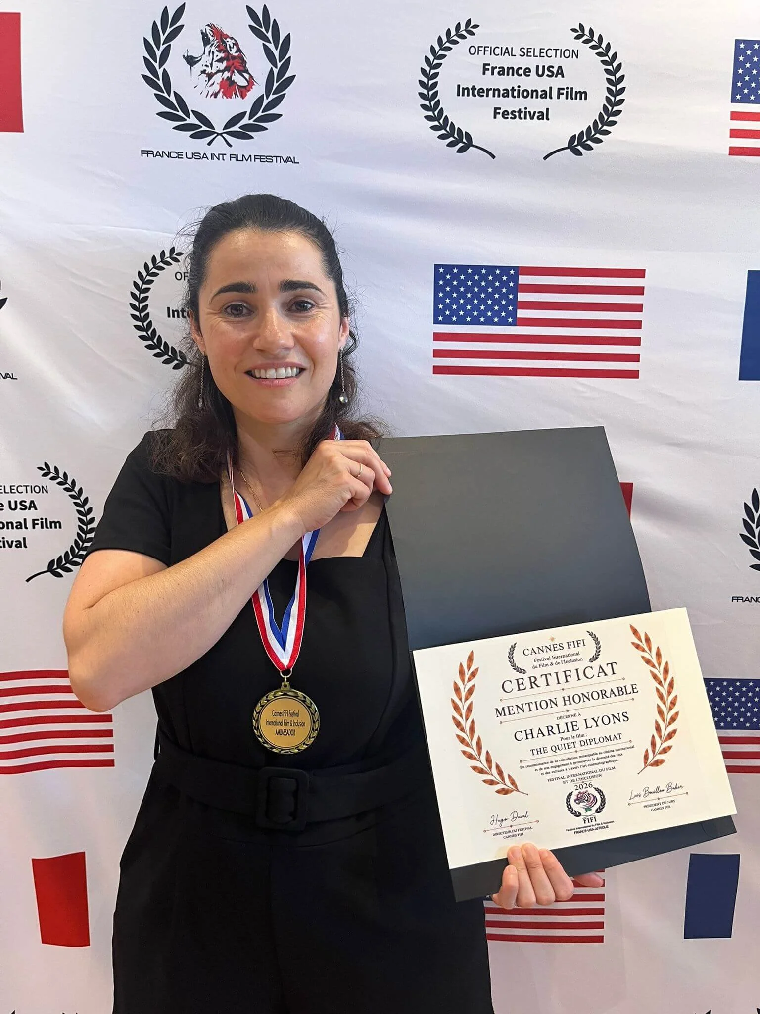 Marion Lemonnier holding honorable mention certificate at the Cannes FIFI International Film Festival.