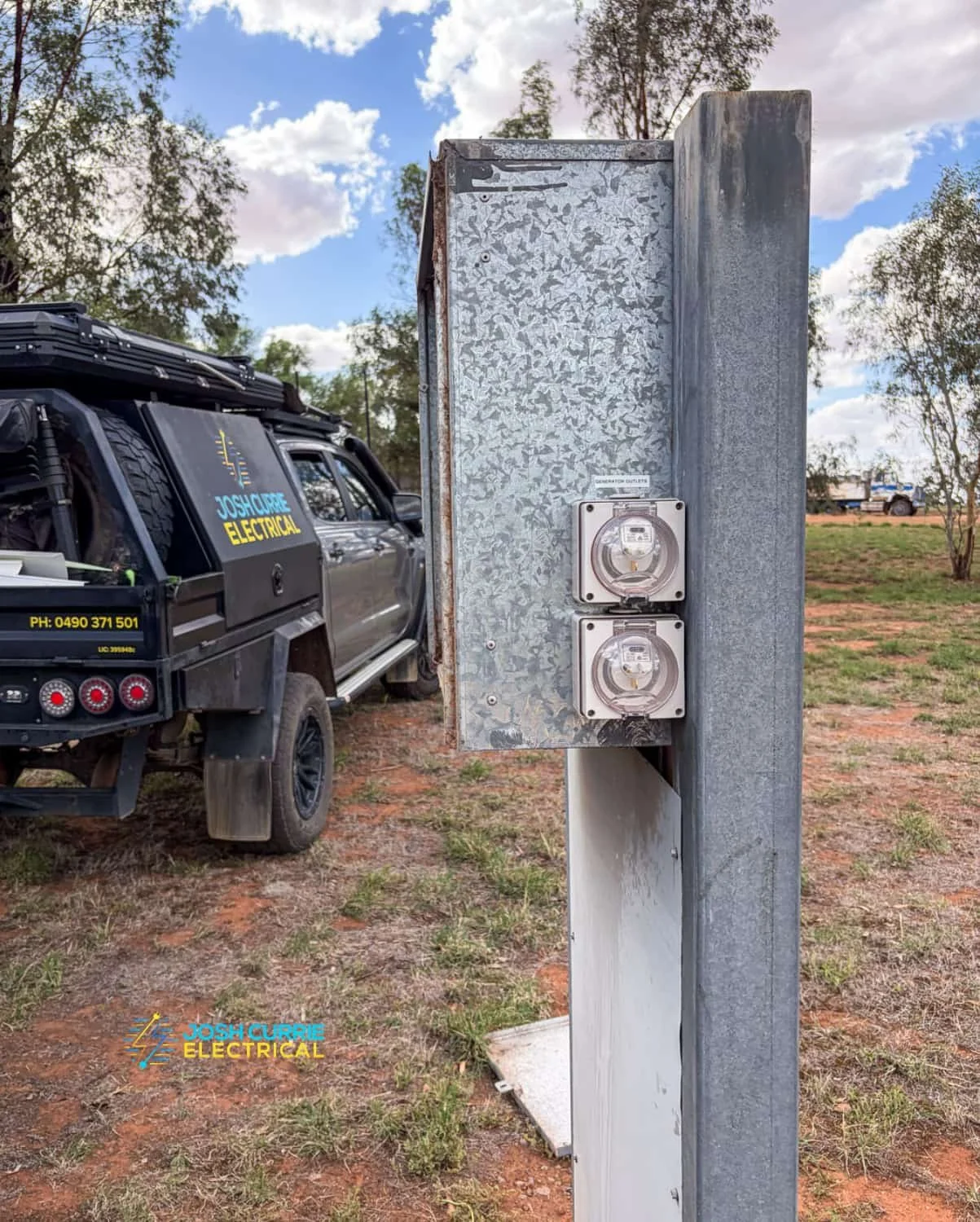 Josh Currie Electrical Ute parked next to a farm switch box in rural setting