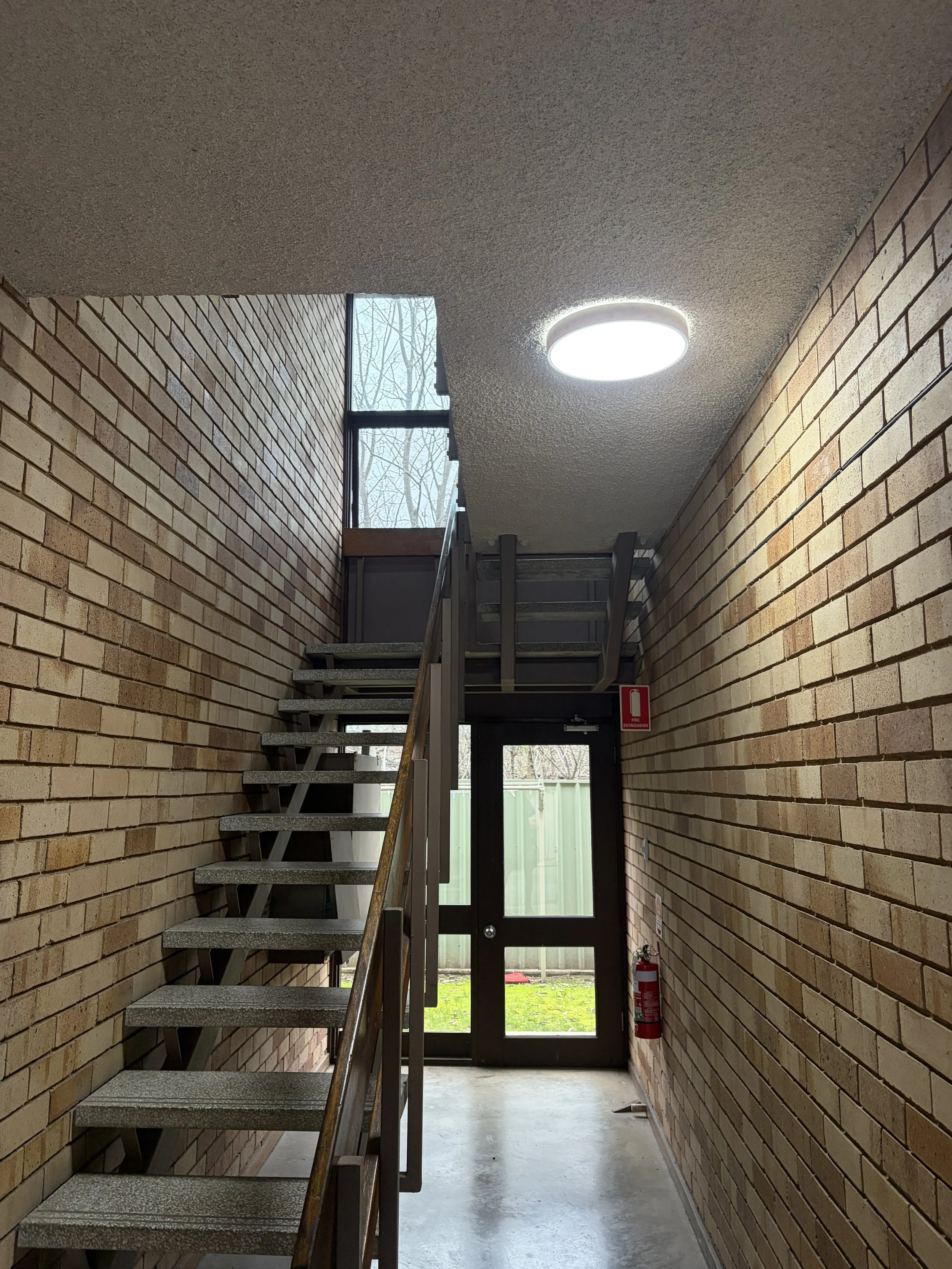 stair case with lighting upgrade in brick rental flats Wagga
