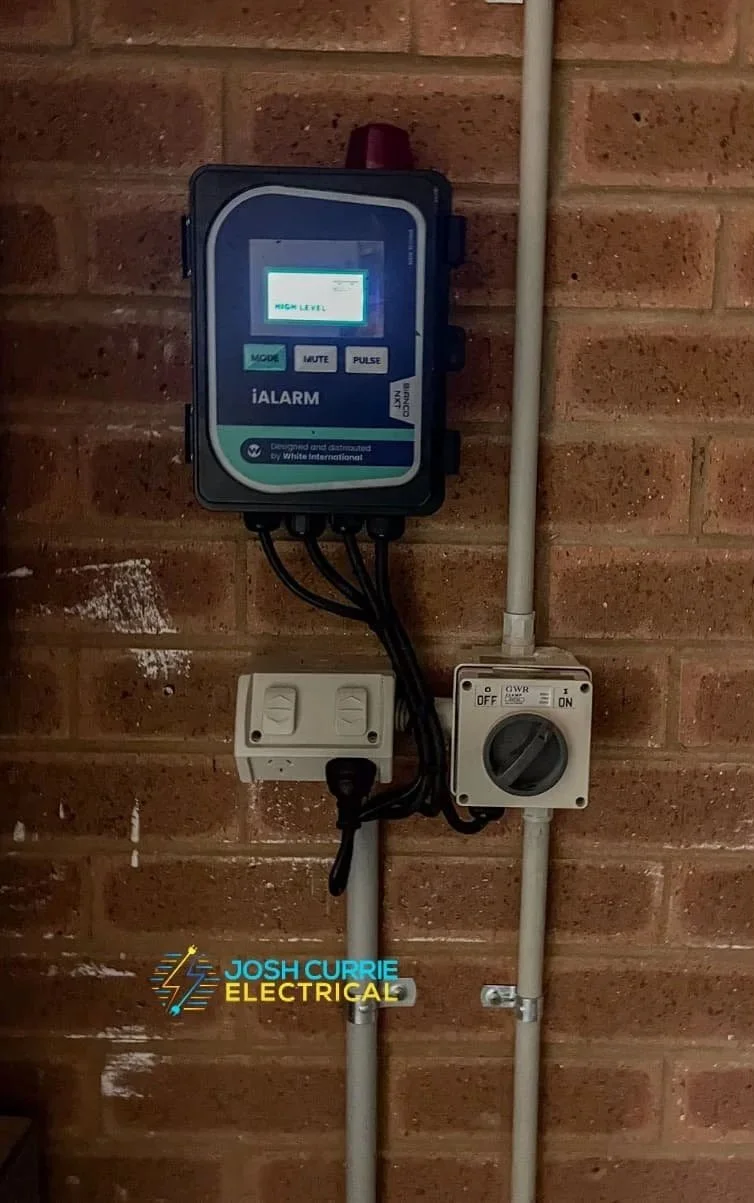 Black alarm unit install onto a red brick internal house wall back to base monitoring