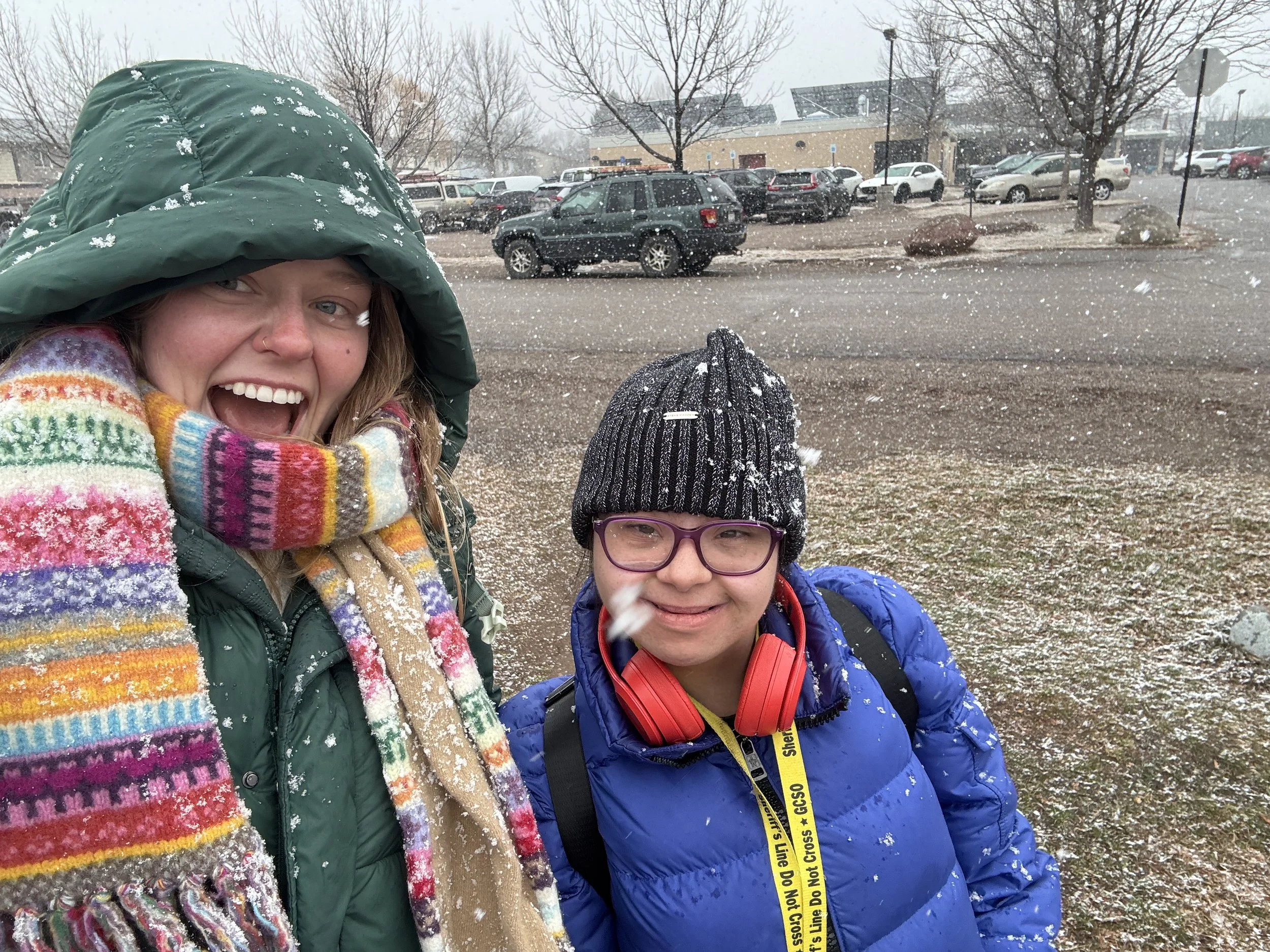 Megan Mindy, Commonground founder, left, smiling beside Commonground client while it's snowing.