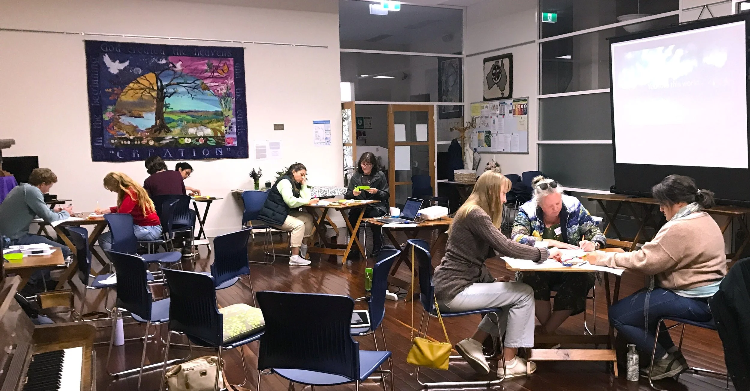 Participants who attended one of the first  workshops in 2022. They're  drawing a rich picture illustrating the key features of the workshop that most influenced them.