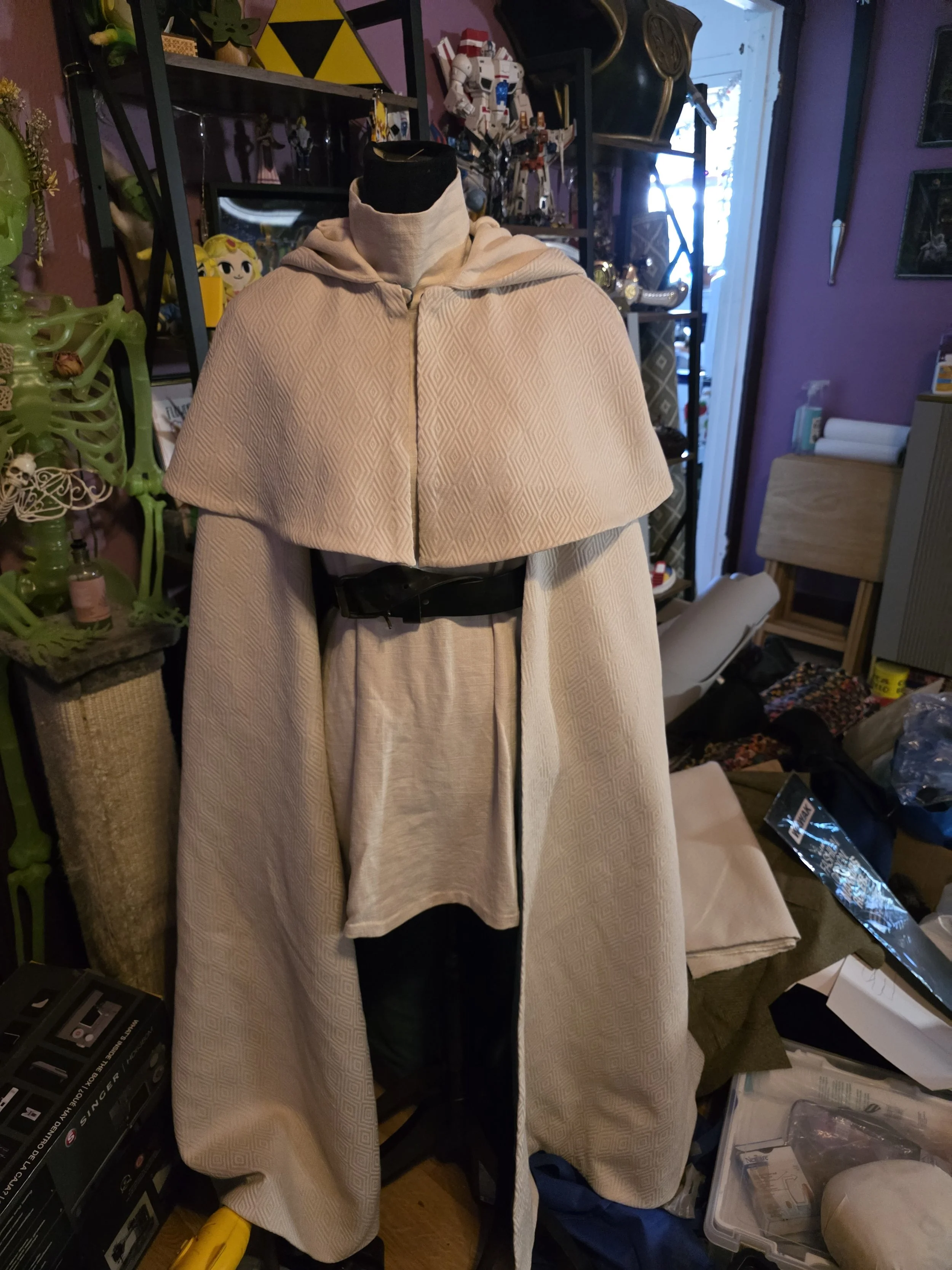 off-white linen cape with an elbow-length capelet, on a dress form